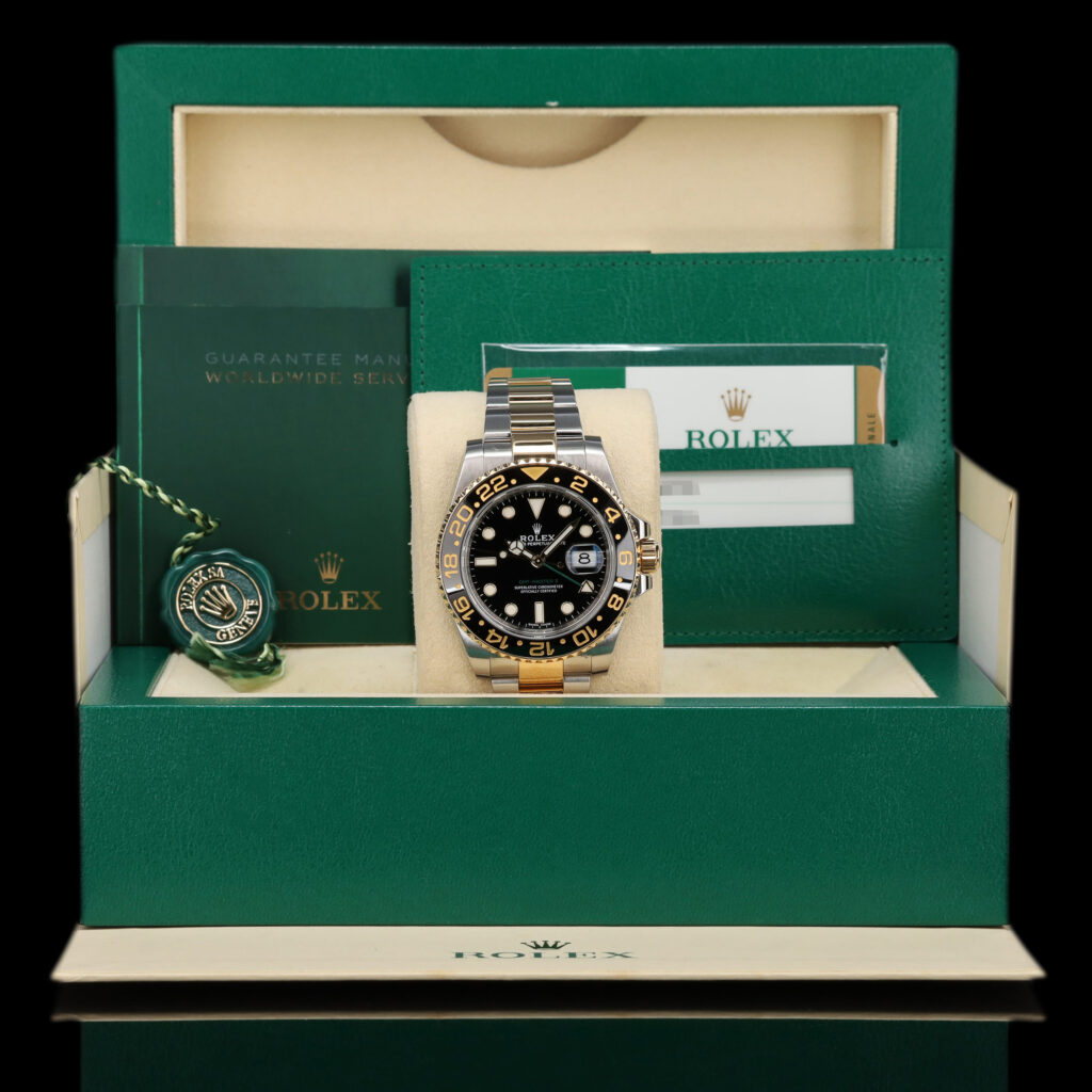 Pre-owned Rolex GMT-Master II reference 116713LN in two-tone steel and yellow gold with black dial and green 24-hour hand