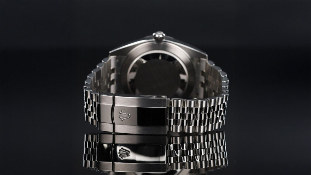 datejust 41 black jubilee bracelet laying on a dark reflective surface showing the back